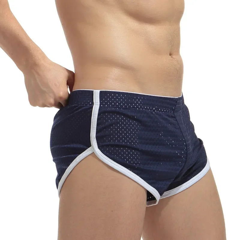 Navy blue athletic shorts with white trim on a white background