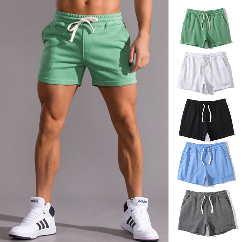Green shorts worn by a person with additional shorts in different colors displayed on the right.