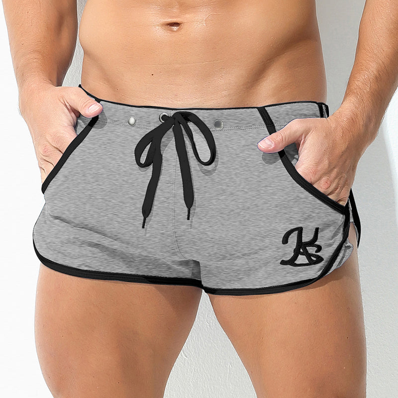 Gray shorts with black trim and logo on a plain background