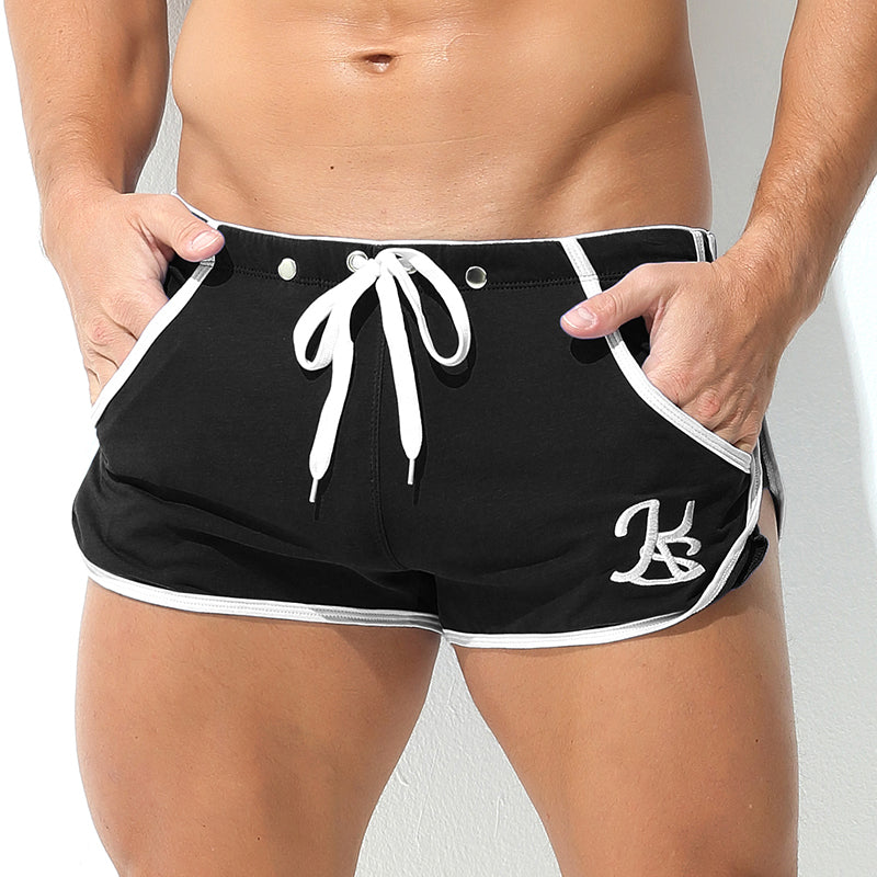 Black shorts with white drawstring and trim on a plain background