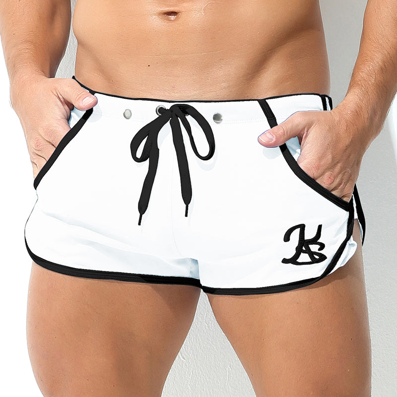 White shorts with black trim and logo on a plain background