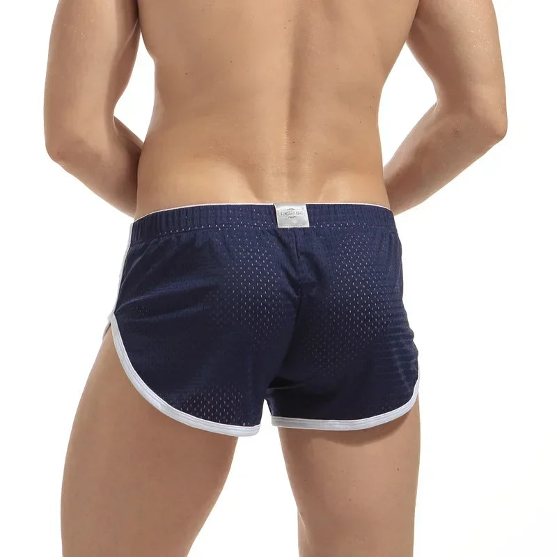 Navy blue athletic shorts with white trim on a white background