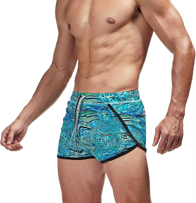 A man wearing blue and turquoise patterned athletic swim trunks with black trim, shown from the chest down against a plain white background.