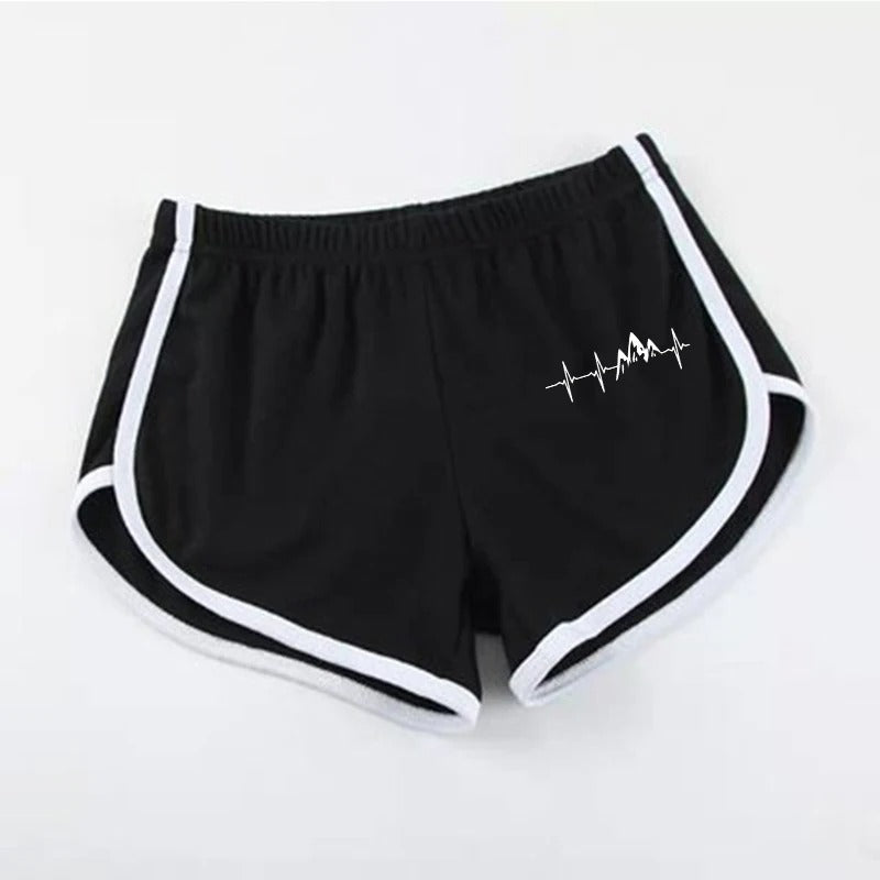 Black shorts with white trim and a logo on a light gray background